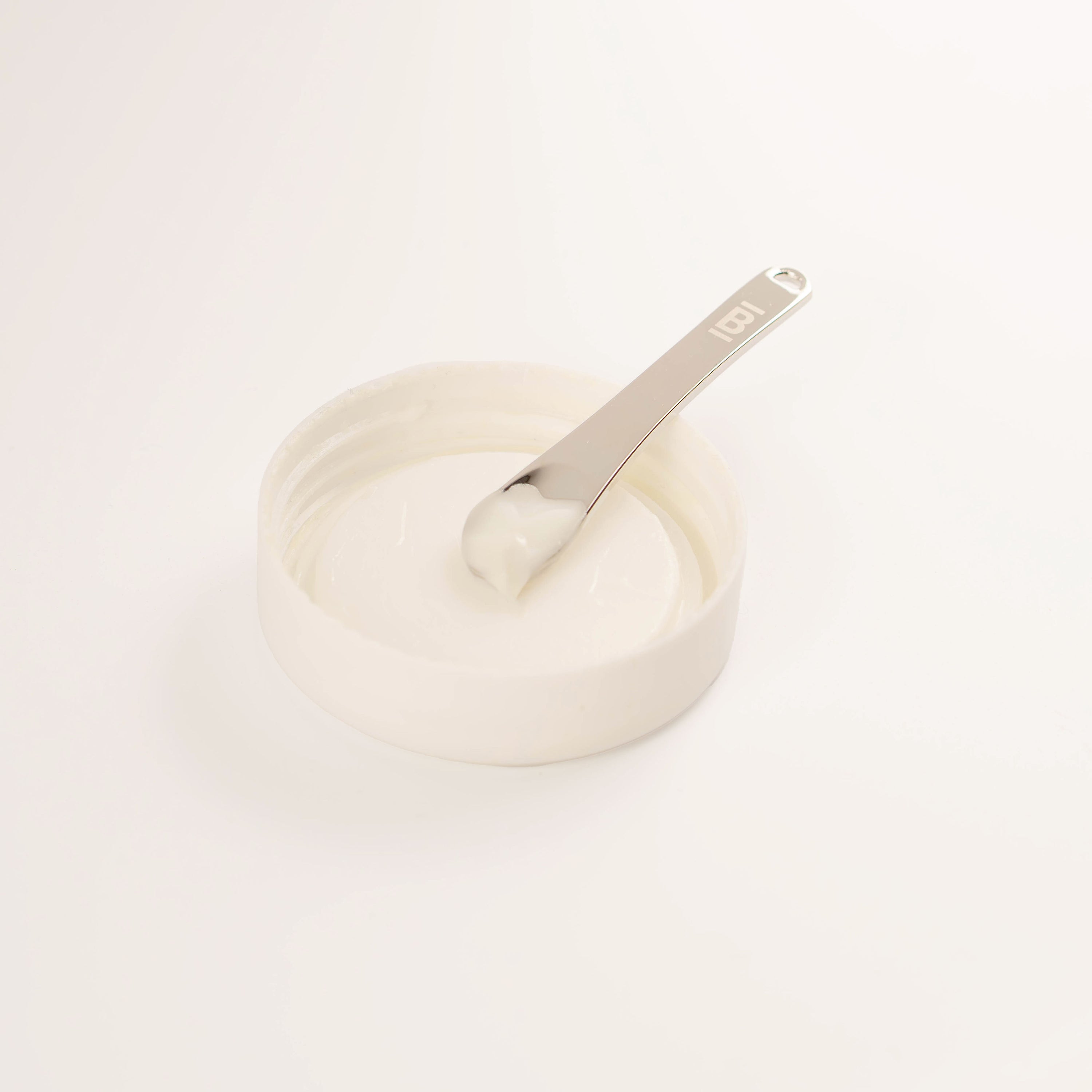 zinc alloy skincare spoon in white cap